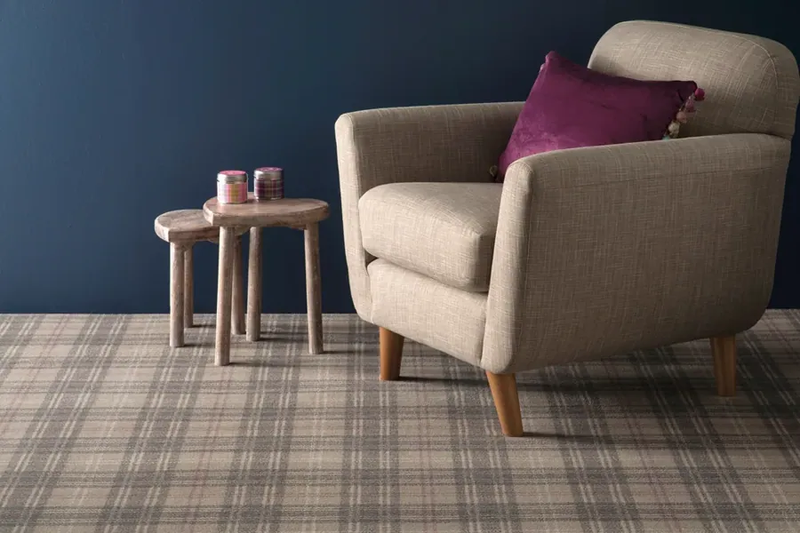 Ulster Braeburn Estuary plaid carpet with an armchair