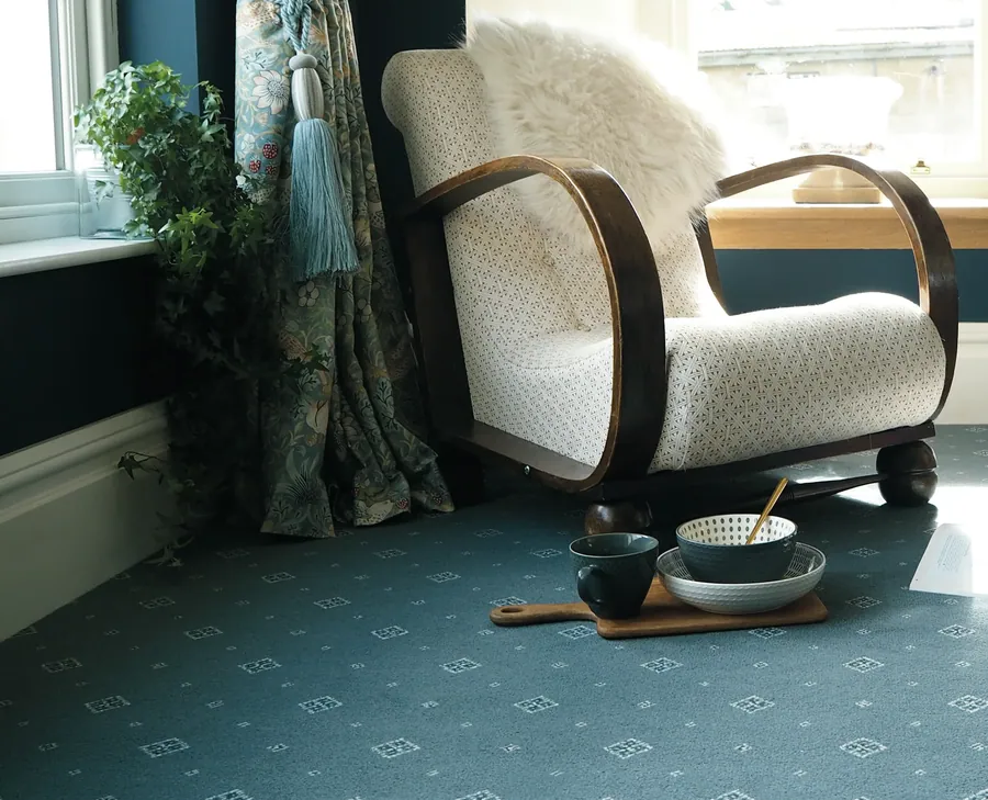 Ulster Tazmin Prussian motif carpet with a cream armchair